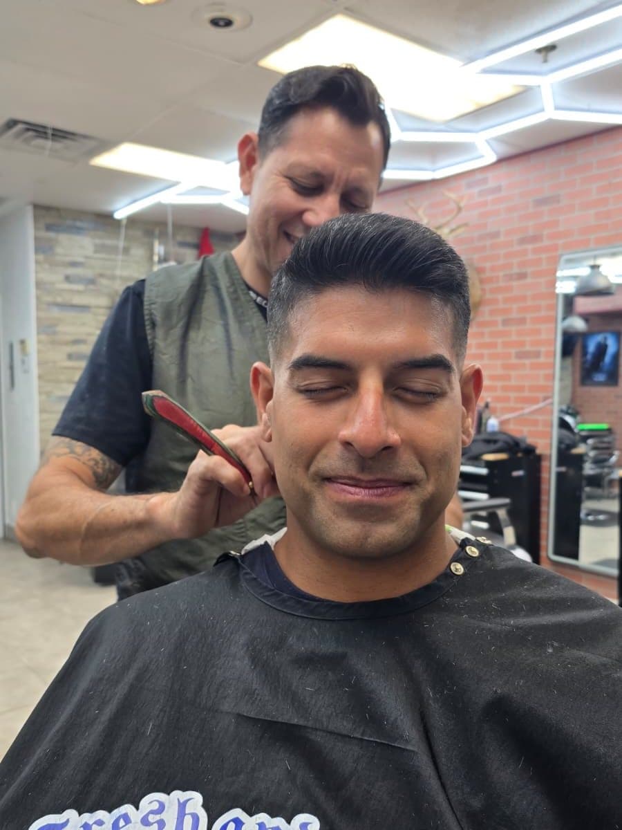 After: short swept-back top with tight sides, beard shaved clean