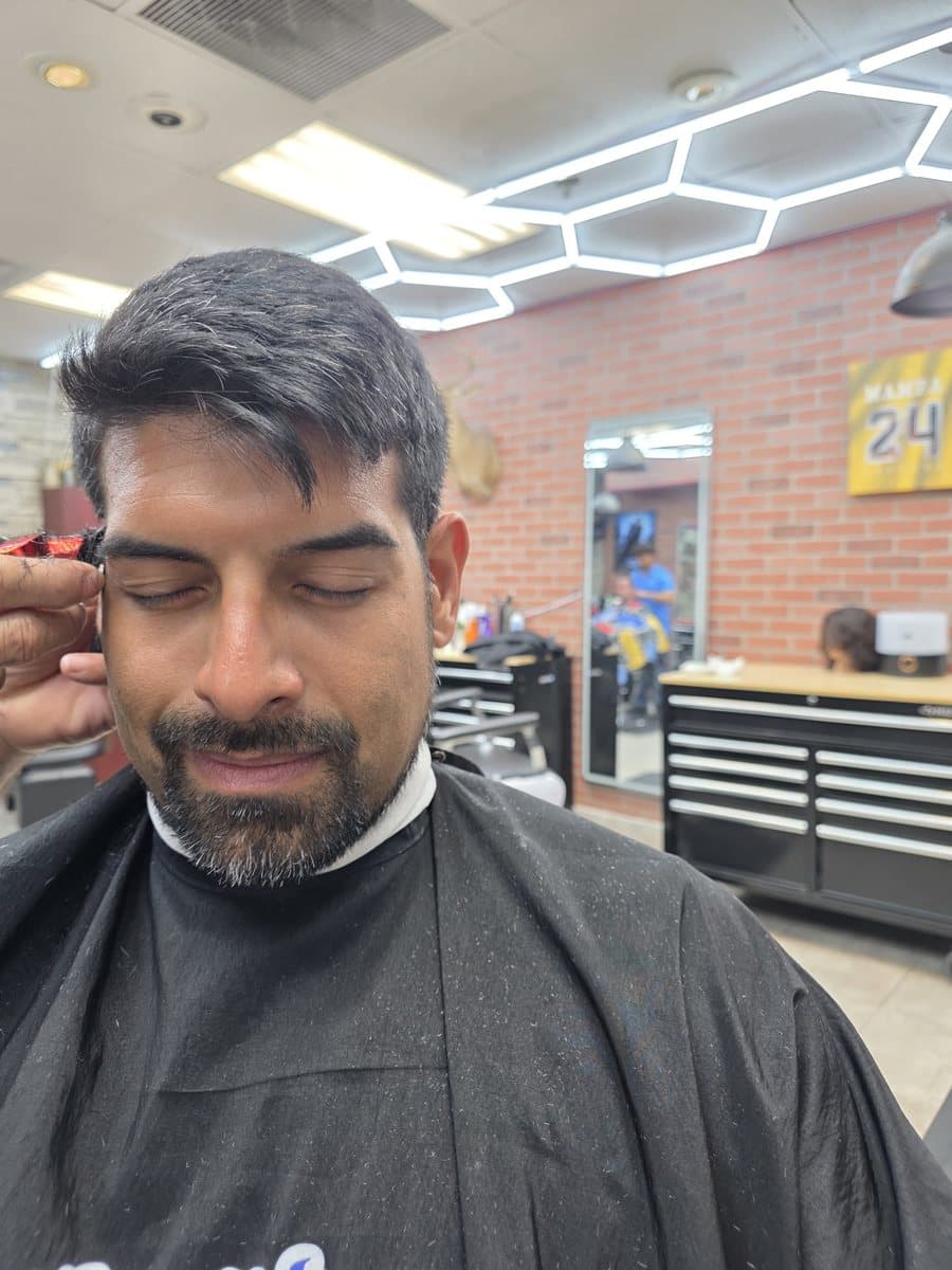 Before: grown-out hair falling over the forehead and a full beard