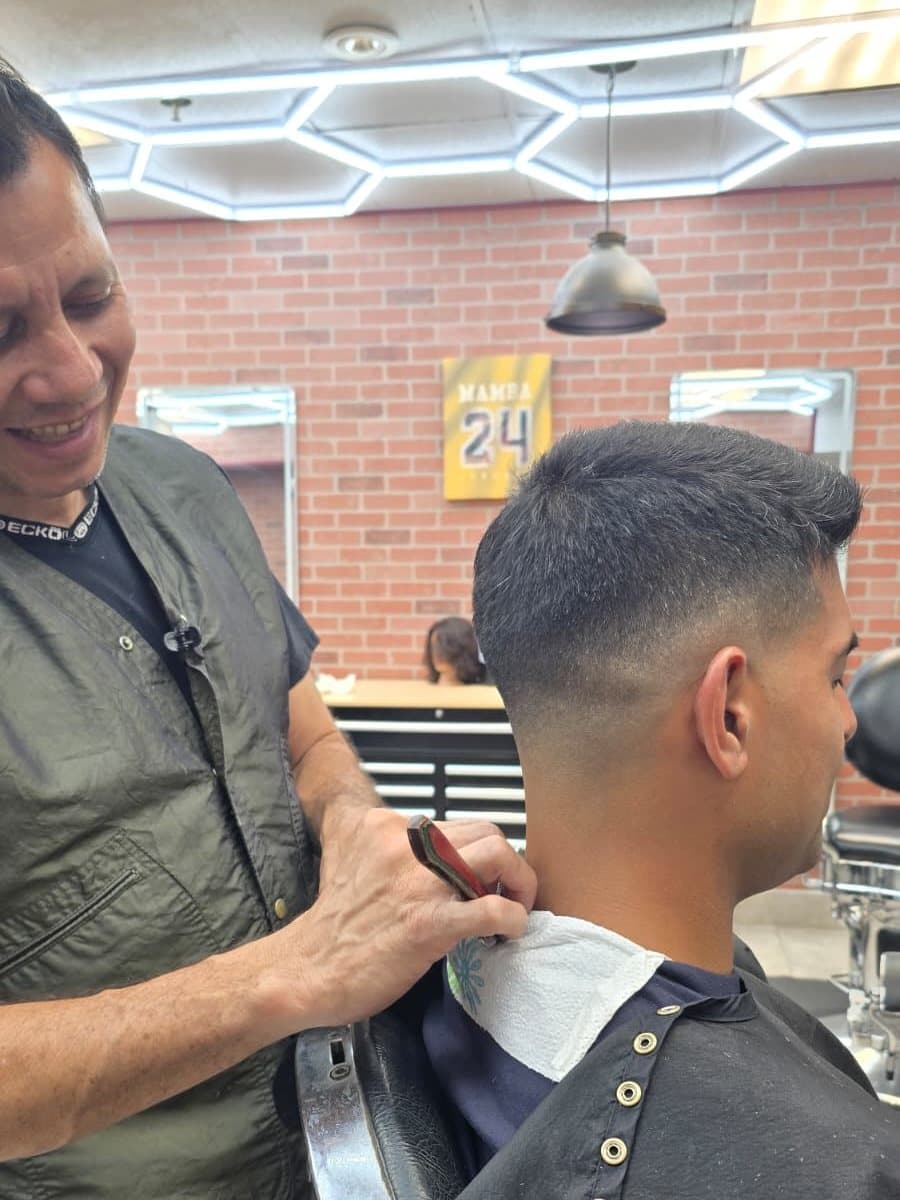Marvin checking the neckline on a fresh fade