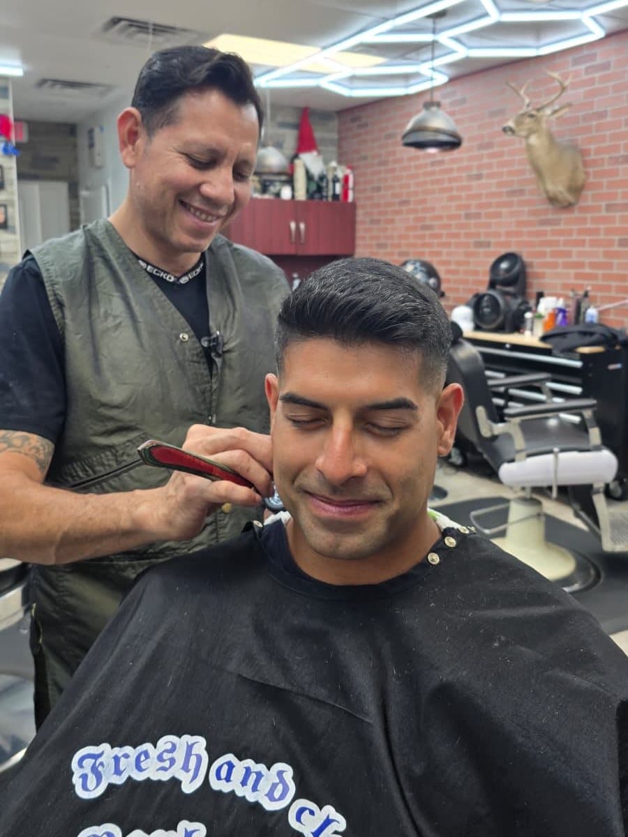 Marvin finishing a fresh fade and a clean shave